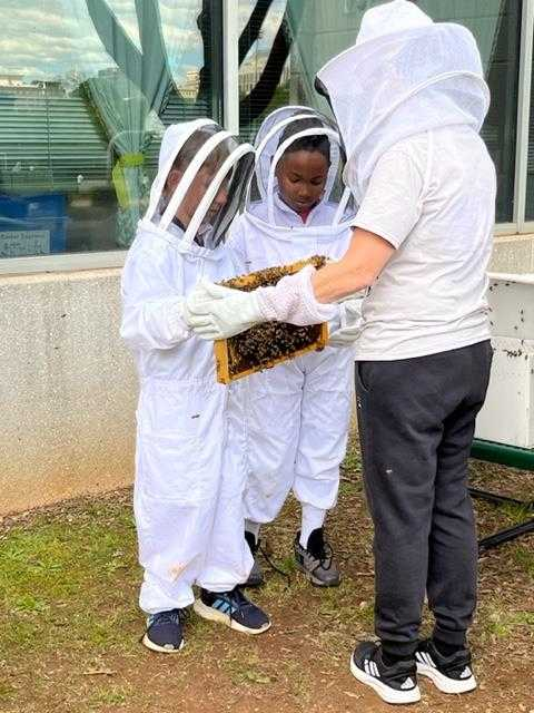 Bee Ambassadors holding part of the new hive. 
